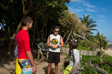   Head Coach, Heriberto Tinoco giving  beginner/intermediate lessons to a surf family